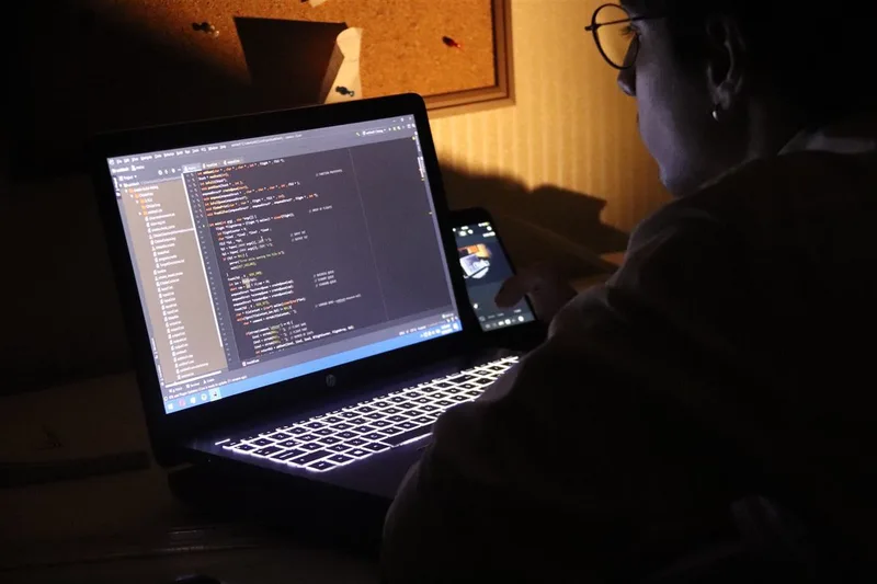 Adem working on software at a laptop